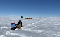 Researchers capture a sediment sample in the field in Antarctica.