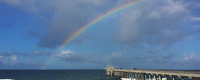 A rainbow appears over Scripps Pier after a November storm