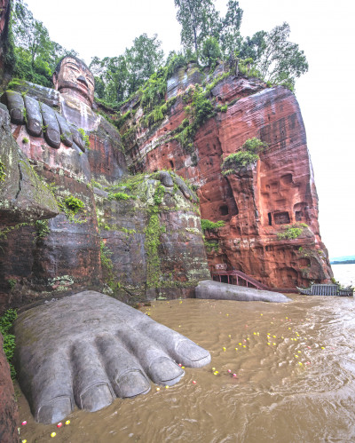 The Leshan Giant Buddha on the MinJiang River, a tributary of the Yangtze. At 233 feet (71 meters), it is the tallest stone Buddha statue in the world. On Aug. 18, 2020, floodwaters reached the toes of the statue for the first time since 1949.