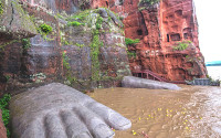 Feet of a Buddha statue in water