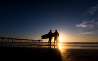 Two silhouettes in front of Scripps pier