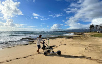 Austin Barnes measuring sand levels on Fort Hase Beach at the Kāne‘ohe Marine Corps Base. We will compare this data to previous surveys to determine seasonal and long-term erosion patterns and their impacts on flood vulnerability.