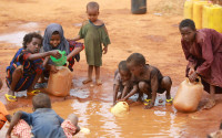 Children collect water at a camp in Dadaab, Kenya