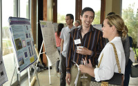 A student and supporter look at a research poster.
