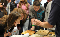 Students look at a marine specimen at a career event