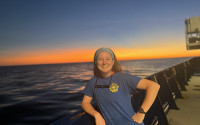Grace Cawley on the R/V Roger Revelle cheesing for an Eastern Indian Ocean sunset