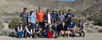 A group of students and professors in the desert.