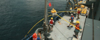 Scientists prepare to deploy an electromagnetic instrument during a 2010 expedition aboard R/V Melville off Nicaragua.