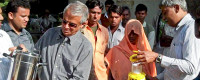 Scripps' V. Ramanathan (left) distributes clean cookstoves in India
