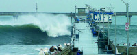 waves crashing over a pier
