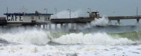 Waves at high tide inundate Ocean Beach Pier during a 2000 storm.