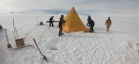 During a field training course in Antarctica, members of the team secure a tent. Photo by Jacob Morgan. 