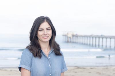 Profile photo of a woman near the ocean