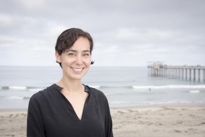 Profile photo of a woman near the ocean