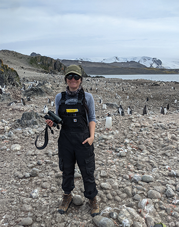 Tammy Russell in the field with penguins.