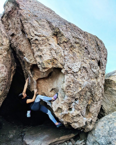 Jaimie Huynh climbing a boulder.