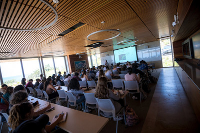 Students attend class in a modern lecture hall