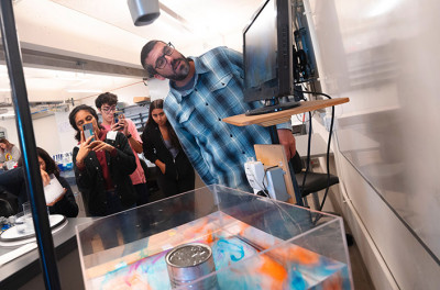 A professor and small group of students conduct an oceanographic experiment