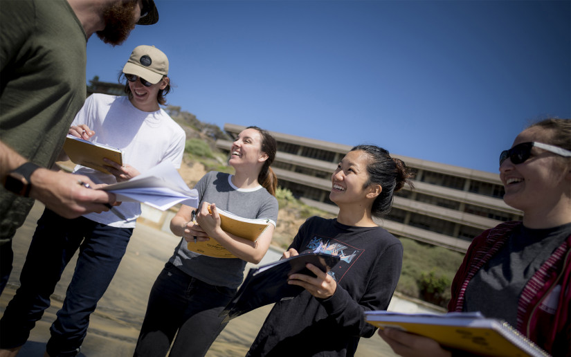 Undergraduate students in a Paleo Biology class on the beach in front of Hubbs Hall.