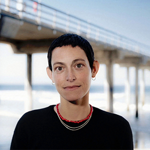 Portrait of a woman with short hair outdoors near a pier