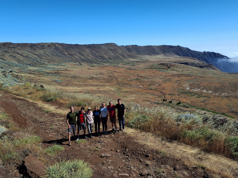 Field group at the rim of the northern shield volcano on Guadalupe Island, with collapsed volcanic caldera in the background. Left to right: James Worthington (Scripps), Marco Rodriguez Delgado (U Colima), Donaxi Borjes Flores (CONANP), Alejandra Reyes Torres (UABC), Rebecca Ruwe (U Mainz), Nick Varley (U Colima), James Muller (Scripps).