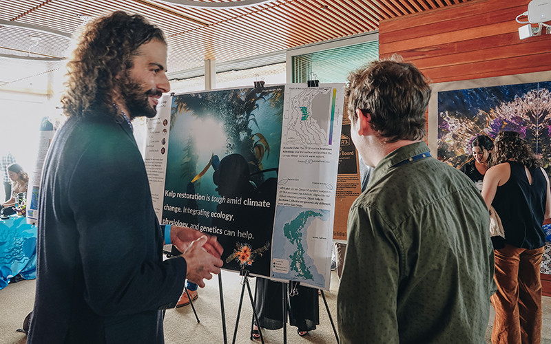 Scripps PhD student Mohammad Sederat shares his research on kelp restoration at the student science showcase poster session. Photo: Kelly Tseng
