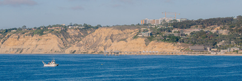 R/V Bob and Betty Beyster shown just off the coast of La Jolla, with the Scripps Oceanography campus and the iconic Scripps Pier shown in the background. Photo: San Nguyen