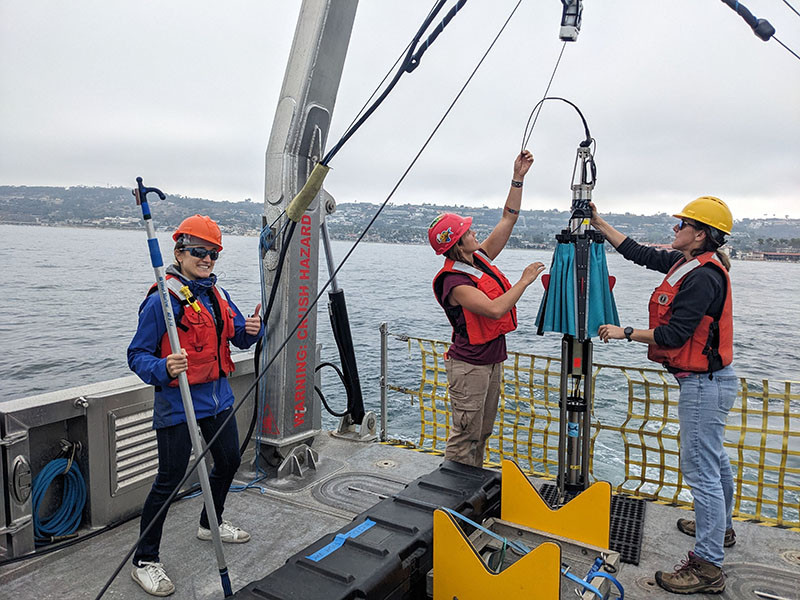 Three oceanographers working on a ship