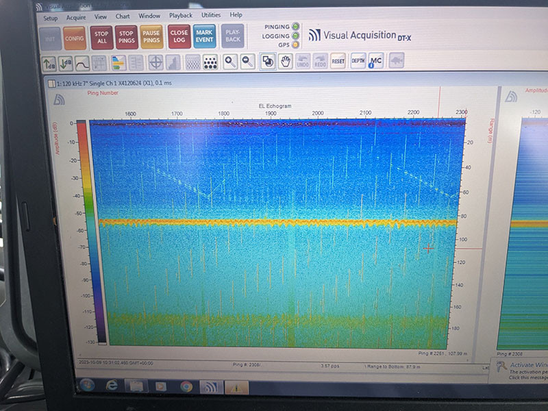 A computer screen displays acoustic data